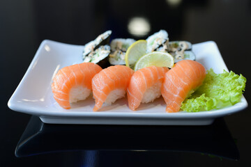 Sushi rolls on white dish. Japanese food.
