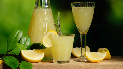 Alcoholic lemon drink limoncello. Italian lemon liqueur, fresh lemons and decanter on table, summer...