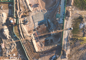 Tower cranes in action at construction site. Crane during formworks. Soil Compactor leveling ground...