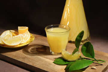 Limoncello liqueur in decanter and shot of limoncello drink. Italian alcoholic drink and fresh...