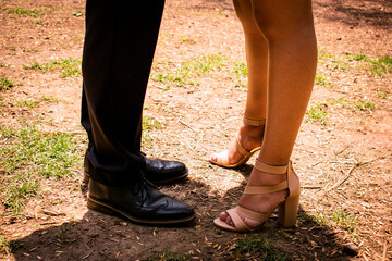 Latin couple standing in front of each other. Close up of lower limbs.