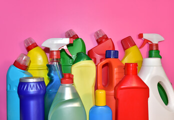 Detergent bottles on pink background. Detergents and laundry concept. Household chemicals for cleaning. Chemical liquid for washing. Concentrated and anti-bacterial liquids for dishwasher.