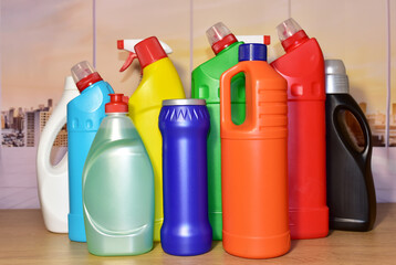 Detergent bottles at kitchen in home. Detergents and laundry concept. Household chemicals for cleaning. Concentrated additive. Anti-bacterial liquids for ​house clean and dishwasher - obrazy, fototapety, plakaty