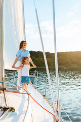 Happy Mother And Daughter Sailing On Yacht During Boat Ride