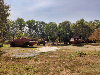 Old and rusty soviet armored vehicles (BTR) from cambodian war. Tropical vegetation in Siem Reap...