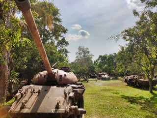 Old soviet tanks from cambodian war T-54 T-55. Tropical vegetation in Siem Reap War Museum....