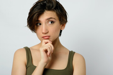 Portrait of a young woman with short hair on a white background.