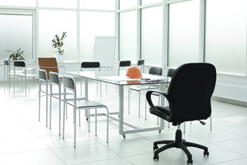 Flipchart construction helmet chairs glass table in office space