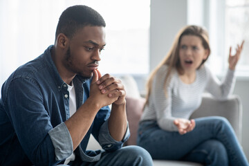 Relationship Crisis. Young Interracial Couple Arguing In Living Room At Home