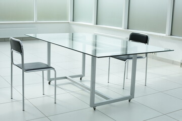 Glass table and chairs in a bright office space