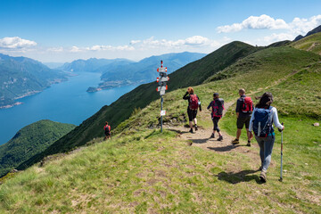 Trekking scene on Lake Como alps (the arrows indicates the names of the locations reached by the...