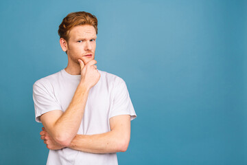 OMG! It's incredible! Portrait of amazed shocked young man looking at camera while standing isolated over blue background. Close up portrait of man keeping his mouth open.