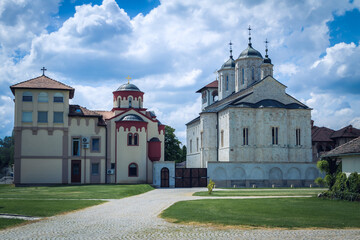 Fototapeta na wymiar Serbian Orthodox Monastery with cloudy sky. Big Orthodox Monastery in Serbia.