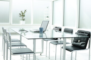 Laptop medical stethoscope coffee cup phone day planner on glass table in office space