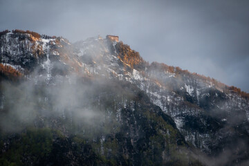 Mountains buried in fog around Lake Bohinj in Slovenia during colorful sunset