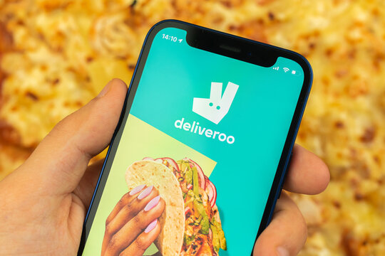 Kharkov, Ukraine - May 28, 2021: Man use Deliveroo food delivery application