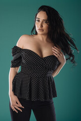 Plus size attractive sexy fashion model on green studio background, body positive concept.