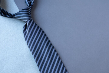 Striped tie or necktie or cravat on grey background, copy space for text, Happy Father’s Day concept idea,