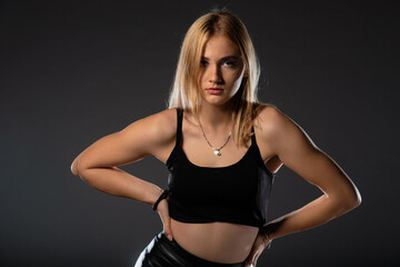 Fototapeta premium Sexy blonde in leather black pants going crazy.