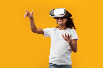 Excited African American Schoolgirl Wearing Virtual Reality Glasses