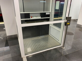 Large new inclusive elevator in the metro or shopping center for people with disabilities and...