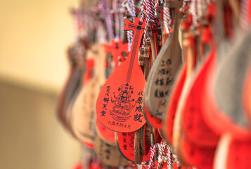 Wooden Ema votive plaques in shape of Japanese Biwa instrument symbol of the godess of the arts and music Benzaiten in the Bentendo hall of Kaneiji temple in Ueno park.