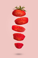 Floating levitating ripe strawbery on a pink background. Vitamins, healthy food concept.