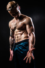 Fototapeta na wymiar Man on black background keeps dumbbells pumped up in fitness bodybuilding sexy arm strong athletic person pectoral. Lift sportive adult, one fit View from the bottom up good press beautiful muscles