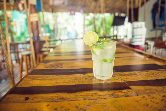 Colorful tropical cocktails on wooden bar. Mixology in pool holiday setting. Caribbean cocktails. Colorful cocktails in caribbean bar hotel.