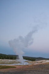 Old Faithful geyser eruption in Yellowstone National Park, Wyoming, USA