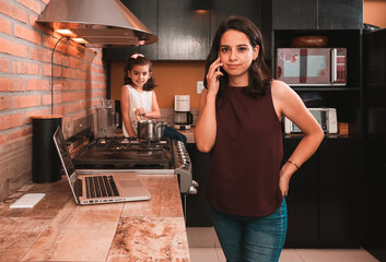 Mother and daughter sharing kitchen and work, lifestyle