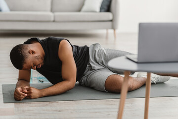 Sporty Black Man Feeling Bad During Online Workout At Home