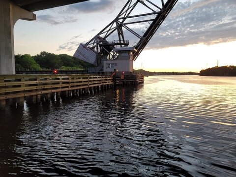 Drawbridge at sunset over river