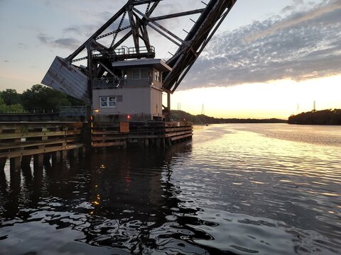 Drawbridge at sunset over river