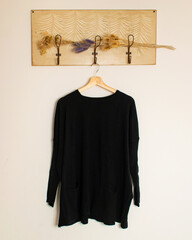 black T-shirt hanging from a hanger