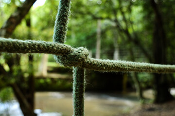Tied rope brings safety by the edge of the river.