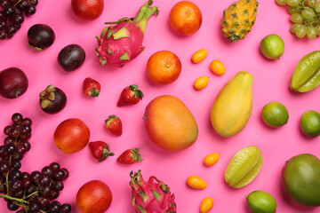 Many different delicious exotic fruits on pink background, flat lay