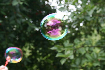 Soap bubbles in the airю Soap bubble flying in the park. Kids party. 