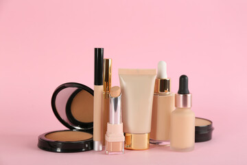 Foundation makeup products on pink background. Decorative cosmetics