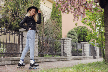 Young woman roller skating on spring day