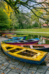Fototapeta na wymiar Colorful boats floating in the lake of Bom Jesus, Braga, Portugal in autumn seasons