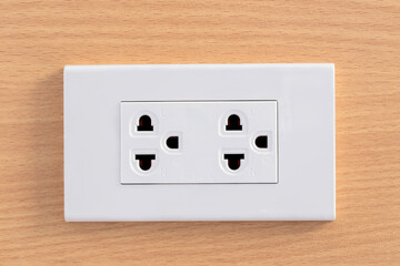 Electrical plug socket on wooden wall, background. Close-up