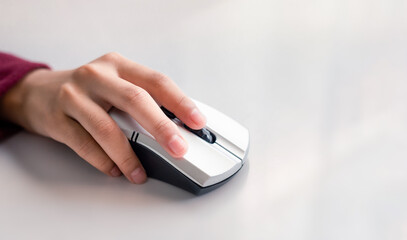 Woman's hand with computer mouse on white. Close-up shot
