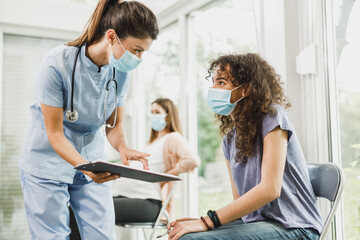 African American Girl Talking To Nurse Before Covid-19 Vaccine