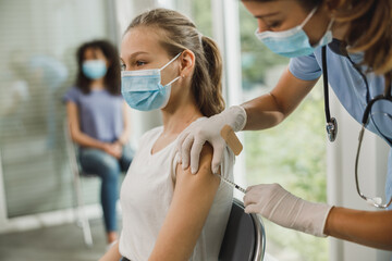 Teenager Girl Getting Vaccinated Due To Covid-19 - obrazy, fototapety, plakaty