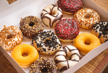 Assortment of donuts of different flavors in a box. 
