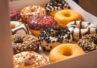 Assortment of donuts of different flavors in a box. 
