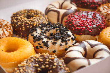 Assortment of donuts of different flavors in a box. 
