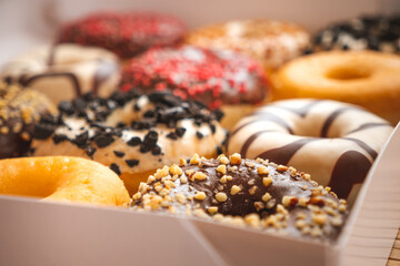 Assortment of donuts of different flavors in a box. 

