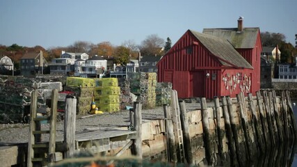 Lobster traps stacked behind a New England fishing shack